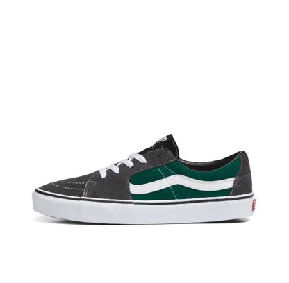 Low-top skate shoes in black with green-and-white side stripes, white rubber sole