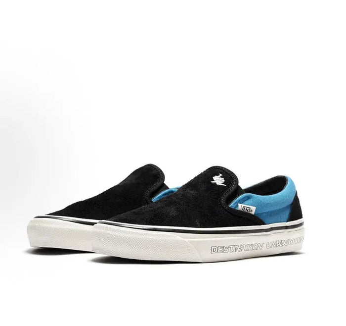 Vans Slip-On sneakers, black canvas with blue stripe detail and white vulcanized sole