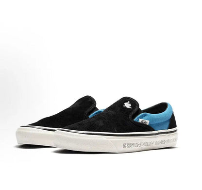 Vans Slip-On sneakers, black canvas with blue stripe detail and white vulcanized sole
