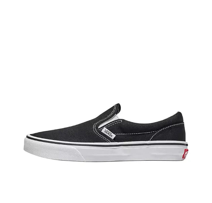 Vans Slip On black canvas sneakers with elastic gore and padded collar, side view.