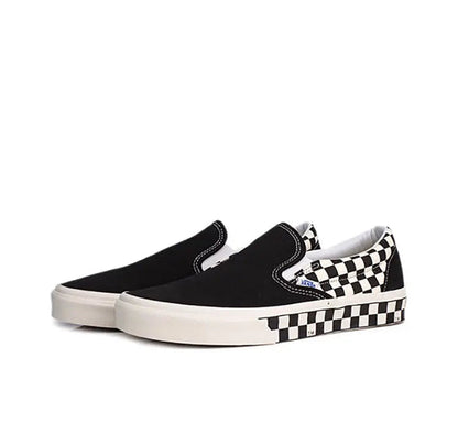 Vans slip-on sneaker, black canvas with checkered detail and white midsole