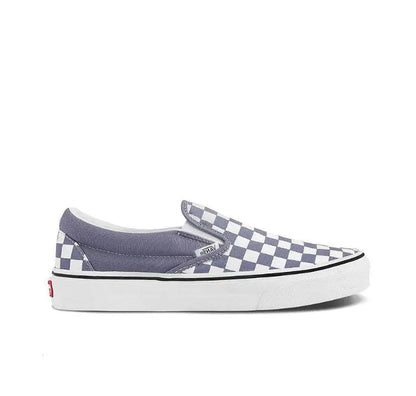 Vans slip-on sneaker side view, checkered upper and white rubber platform sole