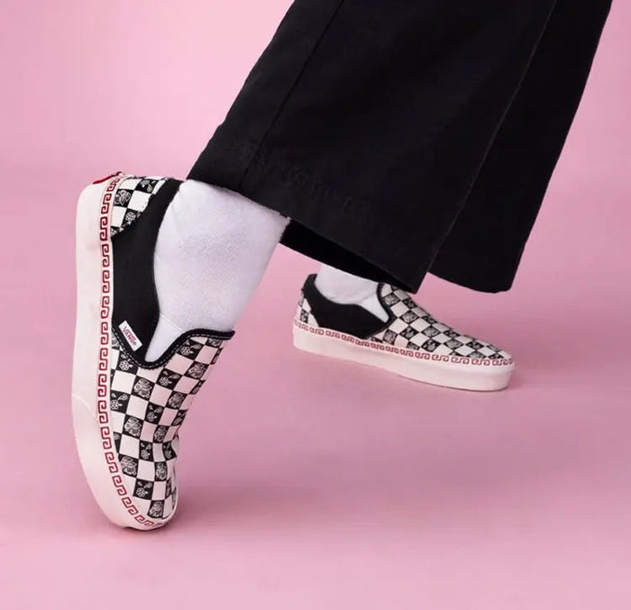 Vans Slip On sneakers, black pants with checker slip-on and red trim