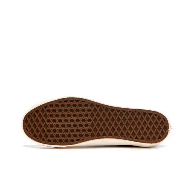 Shoe outsole view with dark brown tread and light edge trim
