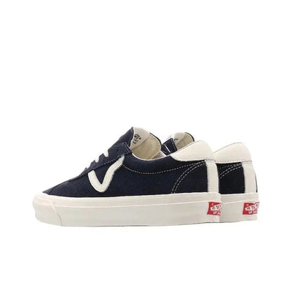 Navy low-top sneakers with white V logo, heel tab, and striped sidewall detail