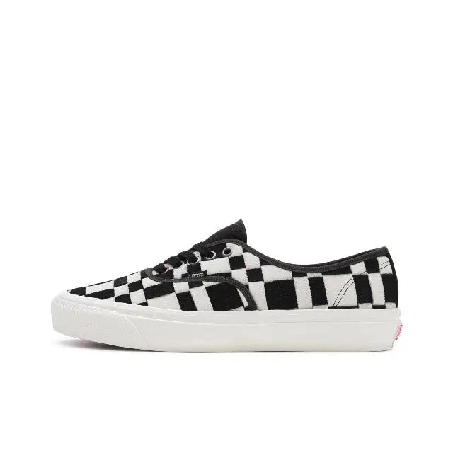 Vans checkerboard slip-on sneakers in white and black, white rubber sole