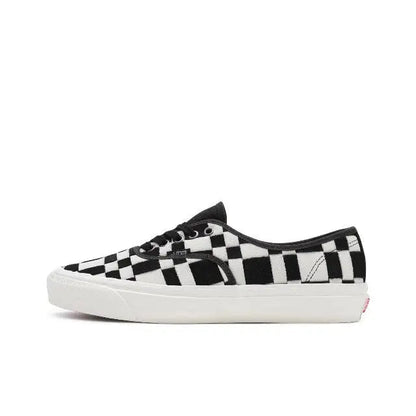 Vans checkerboard slip-on sneakers in white and black, white rubber sole
