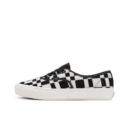 Vans checkerboard slip-on sneakers in white and black, white rubber sole