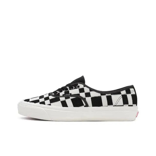 Vans checkerboard slip-on sneakers in white and black, white rubber sole
