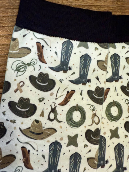 Western trouser socks with dark cuff and cowboy cactus pattern on white fabric