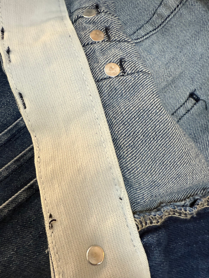 Light denim yoke with gold snap buttons, wide-leg seamed jeans
