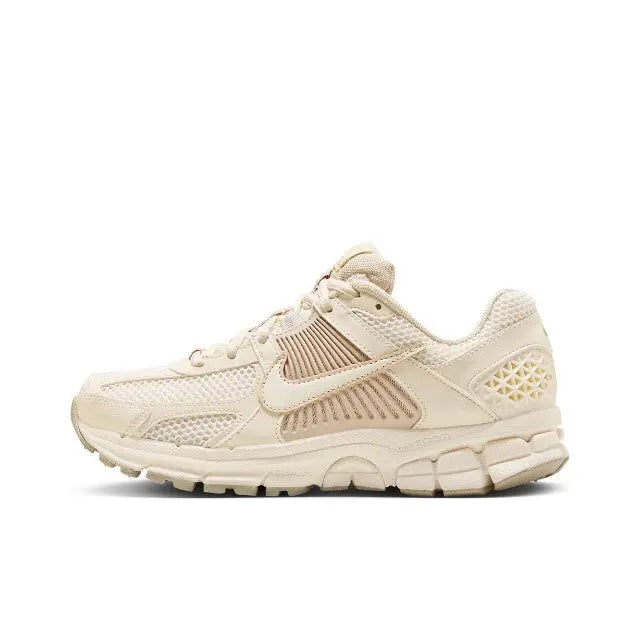 Pale ivory running sneaker with Nike Swoosh on side and mesh panels