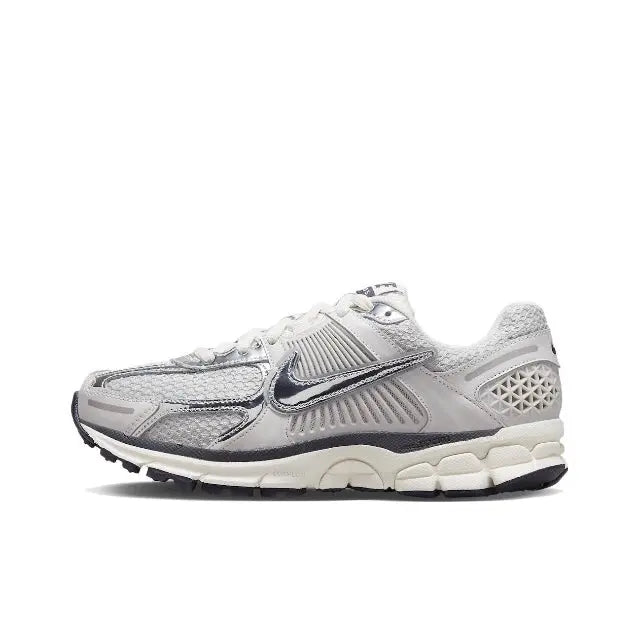 Light gray running shoe with Nike swoosh, mesh panels, lace-up closure