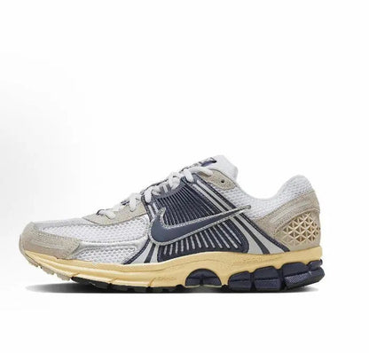 Nike Zoom Vomero 5 SP running sneaker in light gray with navy swoosh and tan midsole