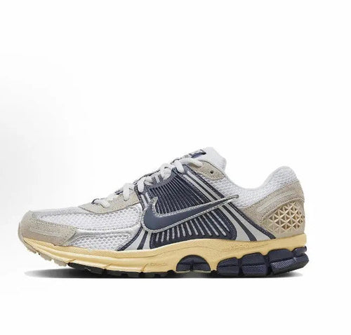 Nike Zoom Vomero 5 SP running sneaker in light gray with navy swoosh and tan midsole