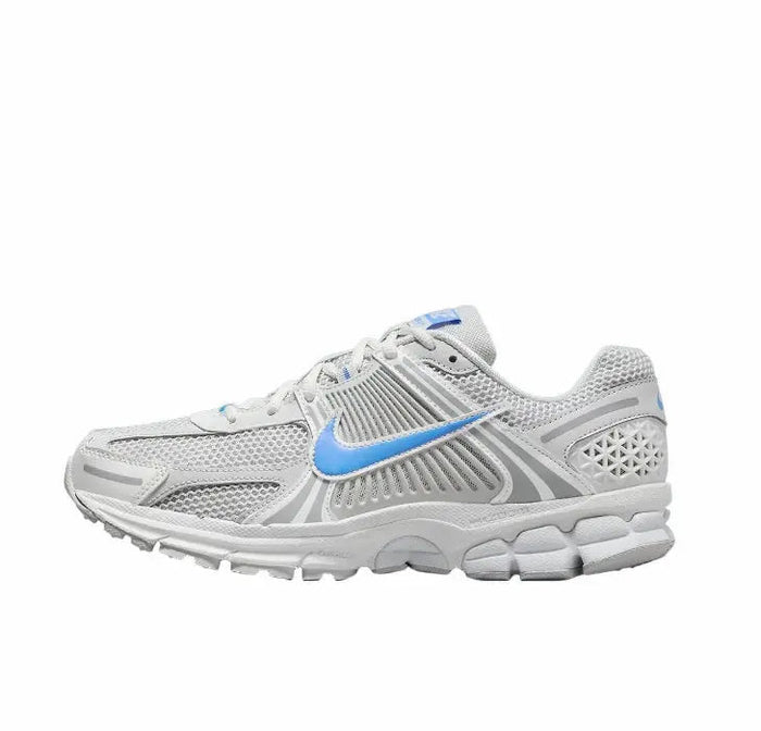 Running shoes in white with blue swoosh, mesh upper, lace-up design, gray overlays