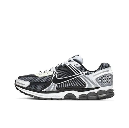 Black, white and dark grey running sneaker with swoosh and sculpted sole