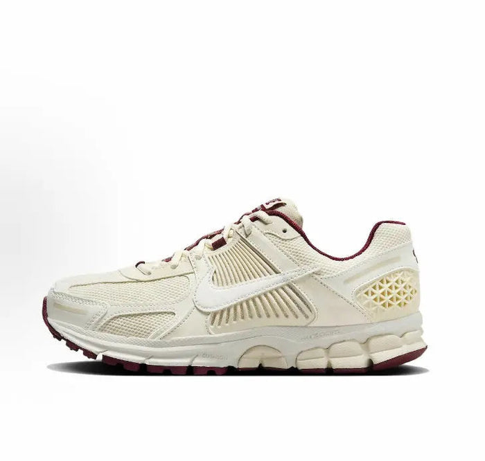 White Nike running sneaker with burgundy accents and cushioned sole