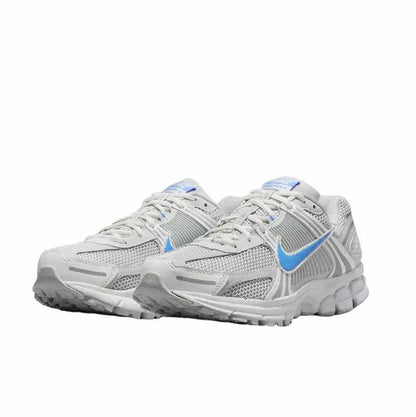 Running shoes side view: white knit mesh with blue accents and gray textured panels
