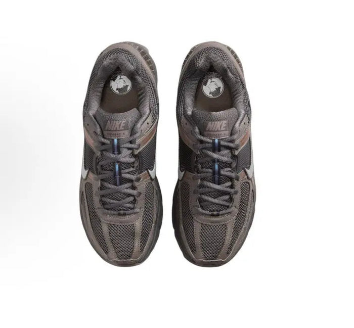 Nike running shoe, dark gray mesh upper, blue laces, heel logo