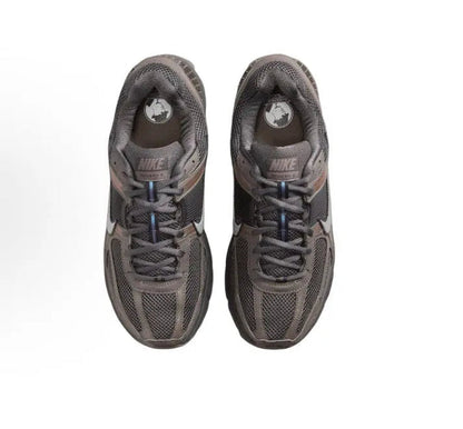 Nike running shoe, dark gray mesh upper, blue laces, heel logo