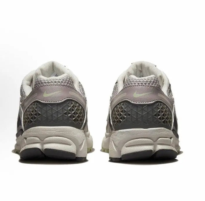 Running sneaker heel view, light gray uppers with dark textured panels, cushioned sole