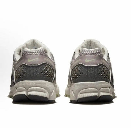 Running sneaker heel view, light gray uppers with dark textured panels, cushioned sole