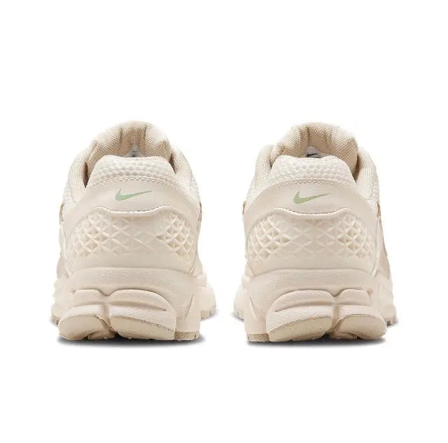 Pale ivory running sneaker rear view with textured heel and Nike Swoosh