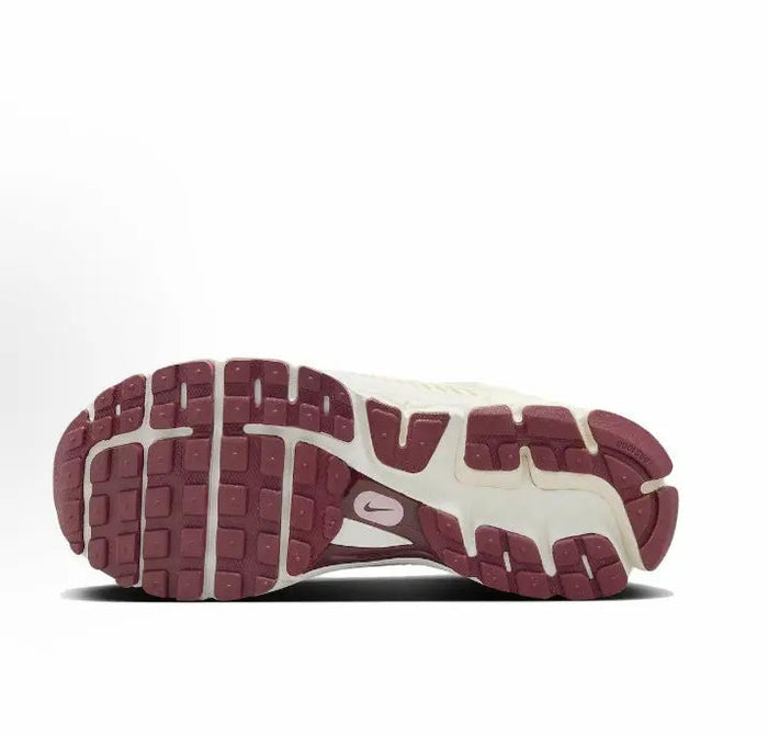 Nike running sneaker outsole with deep burgundy tread and off-white midsole