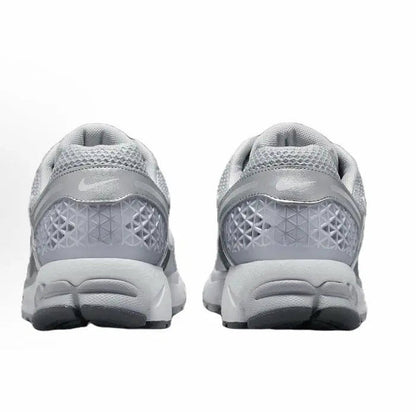 Running shoe heel and outsole, light grey mesh with textured tread