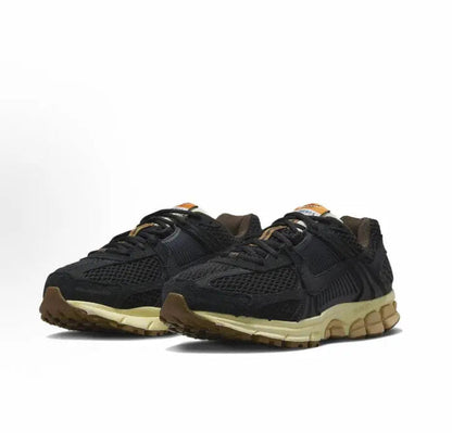 Nike running shoes, black knit upper with tan midsole and rubber outsole