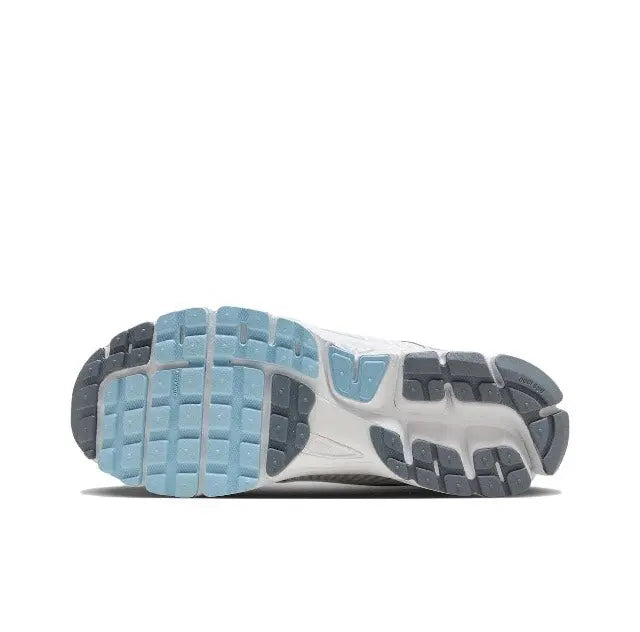 Sole and heel of light grey running sneaker with light-blue tread and accents