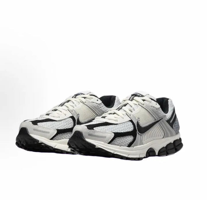 Running sneaker side view with light gray mesh upper and black accents, white laces
