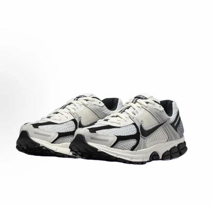Running sneaker side view with light gray mesh upper and black accents, white laces
