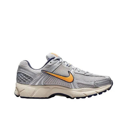 Nike Zoom Vomero 5 SP running shoe, side view in light gray with orange swoosh