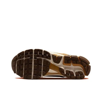 Running sneakers outsole view with dark traction pods and white foam midfoot