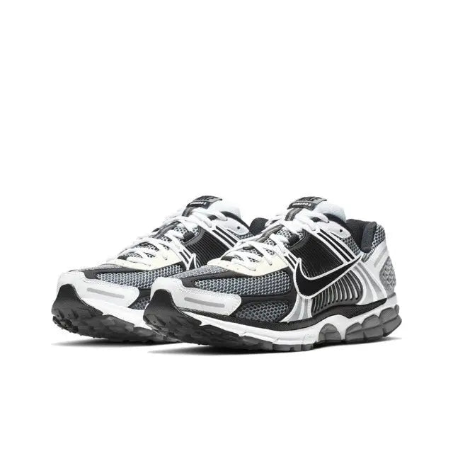 Pair of black, white and dark grey running sneakers with lace-up design
