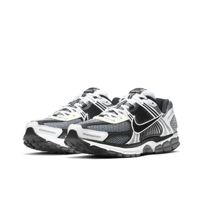 Pair of black, white and dark grey running sneakers with lace-up design