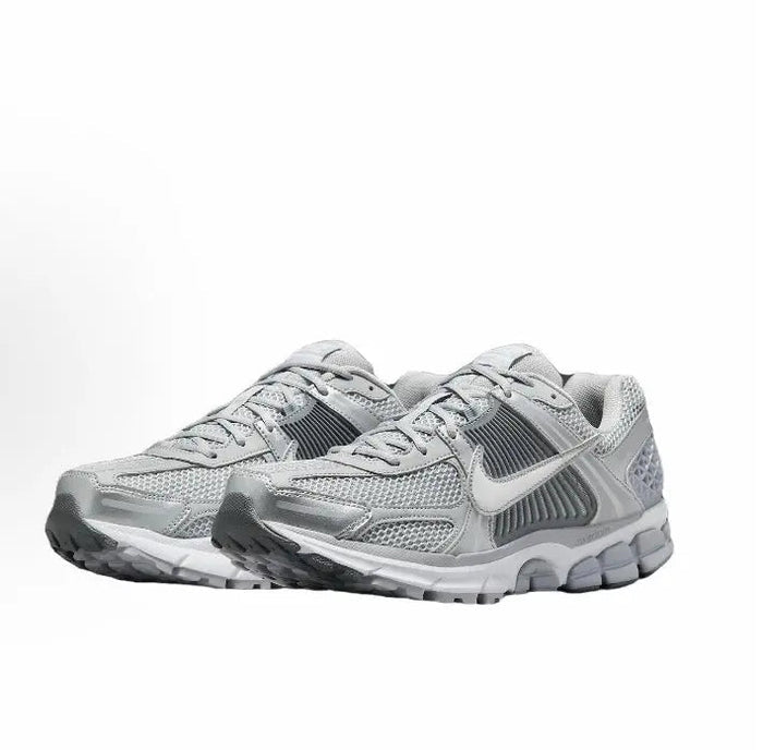 Running shoe pair, light grey upper with padded collar and lace-up front