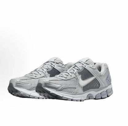 Running shoe pair, light grey upper with padded collar and lace-up front