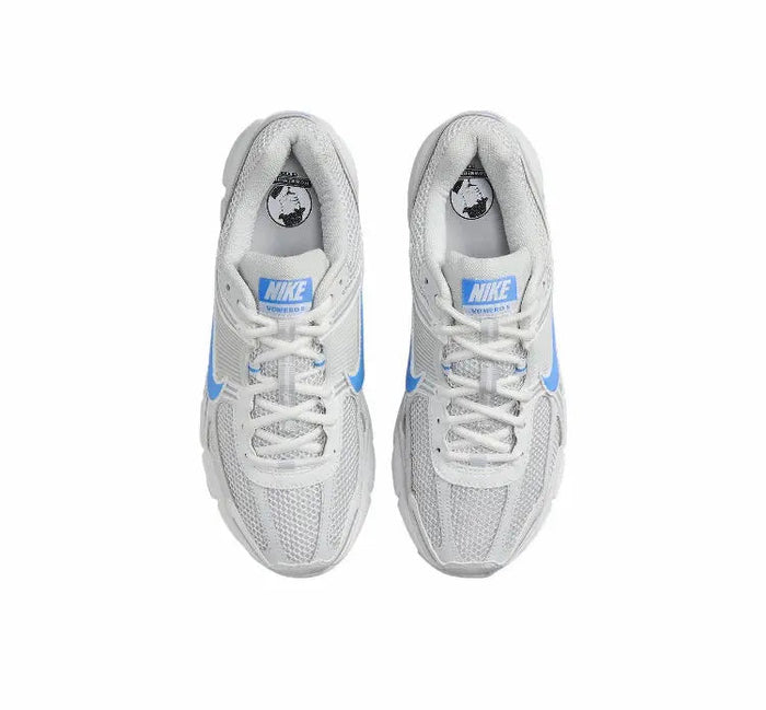Running shoes front view: white uppers with blue stripe details and lace-up closure