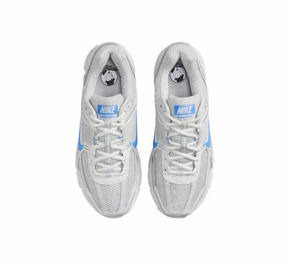 Running shoes front view: white uppers with blue stripe details and lace-up closure