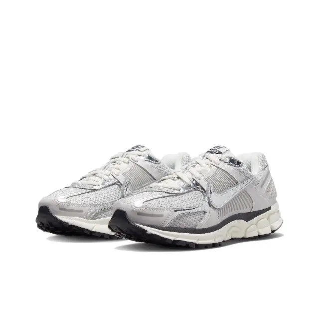 Light gray running shoes with lace-up front, sculpted upper and cushioned sole
