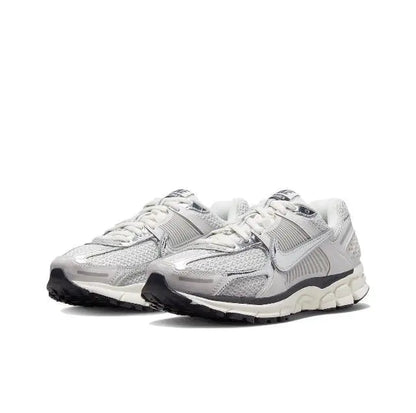 Light gray running shoes with lace-up front, sculpted upper and cushioned sole