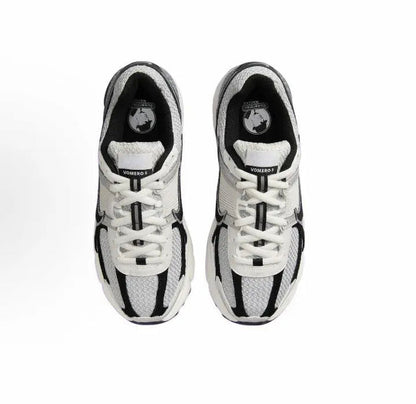Running sneakers front view pair with white laces and black trim around the toe