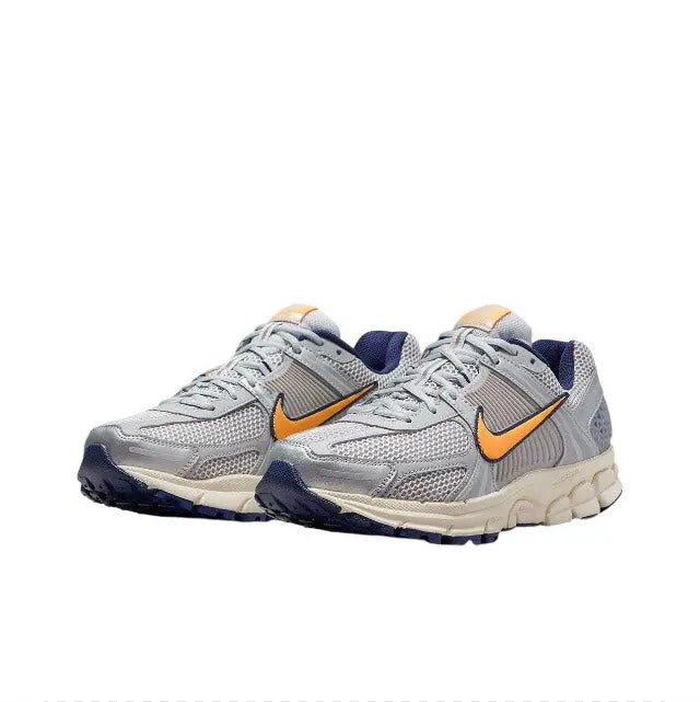 Nike running shoe pair, light gray uppers with orange swooshes and blue heel