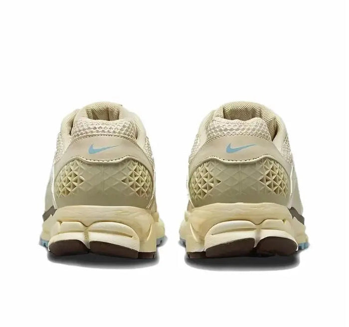 Oatmeal sneakers heel view with Nike swoosh and blue logo detail