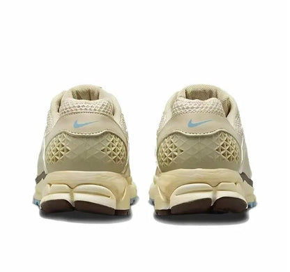 Oatmeal sneakers heel view with Nike swoosh and blue logo detail