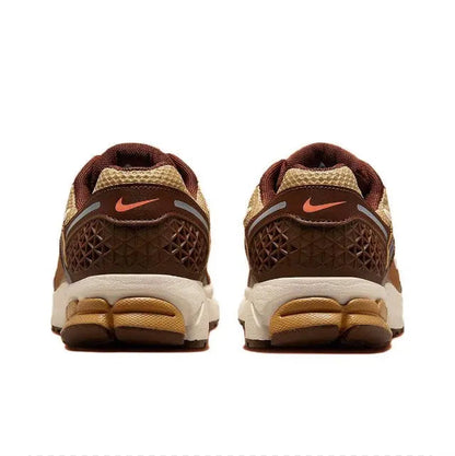 Running sneakers heel view with brown textured panels, white midsole, and orange logo