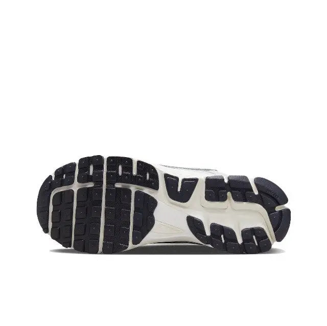 Light gray running shoe outsole with tread pattern and dark rubber segments